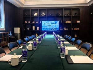 a conference room with a long table with bottles of water at JOY Hotel Hangzhou in Hangzhou