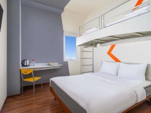 a hotel room with a bed and a desk at Ibis Budget Jakarta Menteng in Jakarta +35 photos