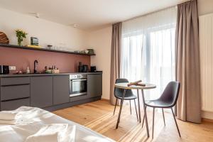 a bedroom with a table and chairs and a kitchen at stuub saig in Lenzkirch