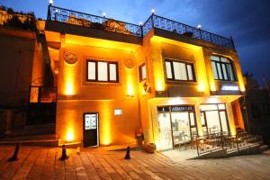 a large yellow building with lights on it at The Castle İnn in Mardin