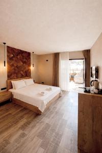 a bedroom with a large bed and a large window at Bohem Hotel in Beykoz