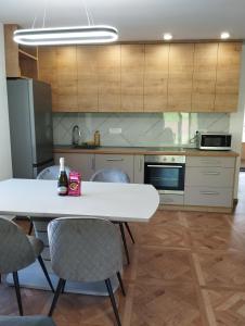 a kitchen with a white table and chairs in it at POČITNIŠKA HIŠA Jan in Mišji Dol