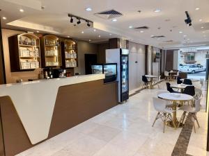 a bar in a restaurant with a table and chairs at Milestone Rise Jeddah in Jeddah