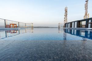 a swimming pool with water in the middle of it at SinQ Prive in Candolim