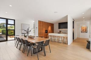 a kitchen and dining room with a table and chairs at Injala House - Designer Masterpiece, Exeter in Exeter