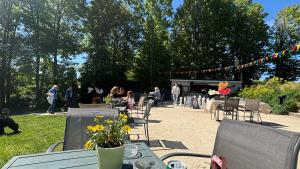 a picnic table with flowers on it with people in a park at Mini studio et espace extérieur in Méry-sur-Oise