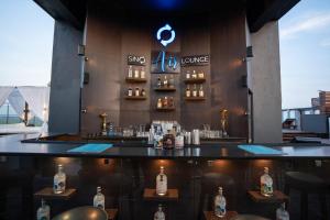a bar at a rooftop bar with bottles of alcohol at SinQ Prive in Candolim