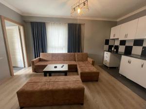 a living room with a couch and a table at Ser Suite Apart Hotel in Esenyurt