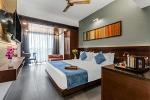 a hotel room with a bed and a television at SinQ Prive in Candolim +63 photos