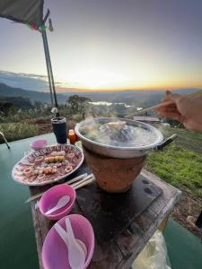 a grill with a plate of food on a table at เขาเจ้าขา-เต็นท์กระโจมเขาค้อ โดมvip in Khao Kho