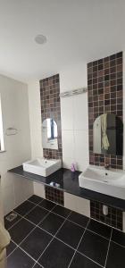 a bathroom with two sinks and two mirrors at Samaya Private Home Panipokhari - 5BHK in Thapathali +25 photos