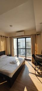 a bedroom with a bed and a desk and a window at Samaya Private Home Panipokhari - 5BHK in Thapathali