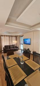 a living room with a table and chairs and a couch at Samaya Private Home Panipokhari - 5BHK in Thapathali