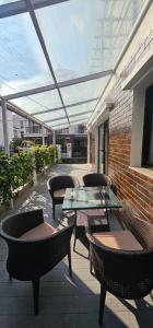 a patio with tables and chairs and a glass table at Samaya Private Home Panipokhari - 5BHK in Thapathali