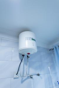 a water tank on the wall of a bathroom at NL Josephine's Hotel, Apartment in Kampala