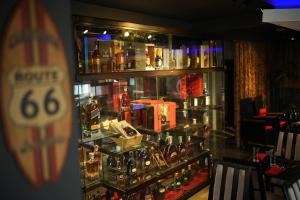 a display case in a bar with bottles of alcohol at Apihap Hotel Daraga Albay in Locsin