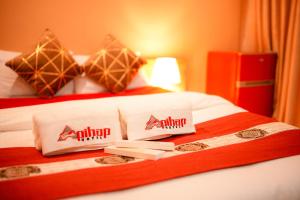 a hotel room with a bed with two pillows on it at Apihap Hotel Daraga Albay in Locsin