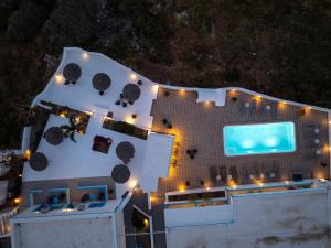 an aerial view of a building with a swimming pool at Ancient Thera Apartments in Kamari