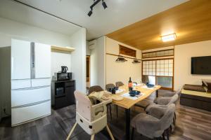 a kitchen and living room with a table and chairs at 糸島 古雅 Koga in Itoshima