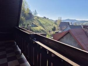 a room with a balcony with a view of a hill at Endurance in Krośnica