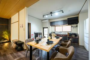 a kitchen and dining room with a table and chairs at 糸島 古雅 Koga in Itoshima
