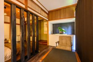 a bedroom with a bed and a chair in a room at 糸島 古雅 Koga in Itoshima