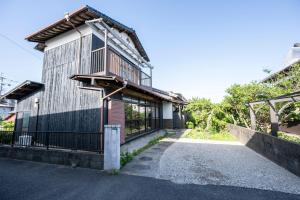 a building with a balcony on the side of it at 糸島 古雅 Koga in Itoshima