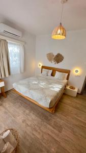 a bedroom with a large bed in a room at Modern Cycladic Sea View House in Ornos