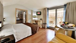 a hotel room with a bed and a desk and a window at Regal Hotel in Brescia