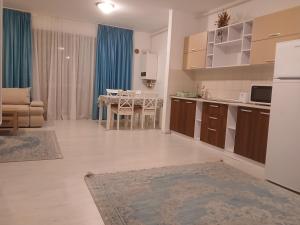 a living room with a kitchen and a dining room at Apart hotel Sara seaview in Olimp