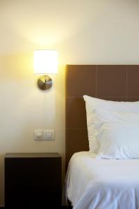 Postel nebo postele na pokoji v ubytování Hotel Girassol - Suite Hotel