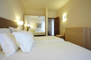 Postel nebo postele na pokoji v ubytování Hotel Girassol - Suite Hotel