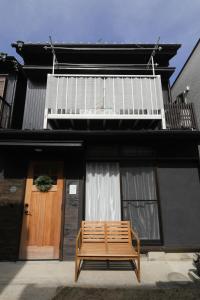 a wooden bench sitting in front of a house at KiyosuBase2 in Kiyosu