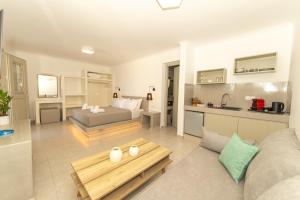 a living room with a couch and a table at Agia Marina Caldera suites in Megalochori +47 photos