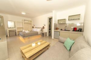 a living room with a couch and a table at Agia Marina Caldera suites in Megalochori