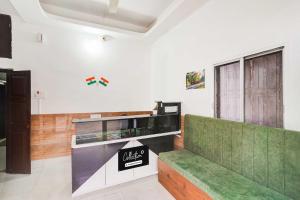 a restaurant with a green bench in a room at Collection O SNT Bus Terminal Siliguri in Siliguri