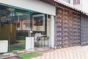a glass storefront with a table in front of a building at Collection O SNT Bus Terminal Siliguri in Siliguri +33 photos