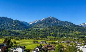 a village in a valley with mountains in the background at Garage Loft in Satteins
