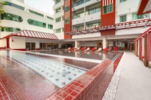 an empty swimming pool in front of a building at Blue Cabin Hotel Formerly A-ONE New Wing Hotel in Pattaya +13 photos