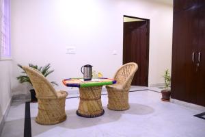 a table and two chairs and a table with a blender at Hotel Roselle Heights in Jaipur