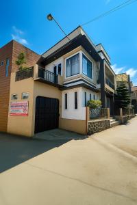 a large house with a garage on a street at Sejiwa Homestay Syariah in Diyeng