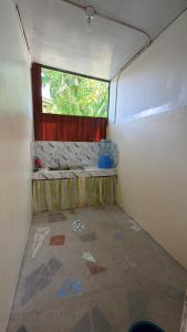 an inside view of a room with a window at Anda Seabreeze Pension Haus in Anda