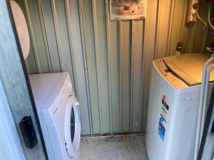 a washer and dryer in a small room at Winganah Cottage in Murdunna