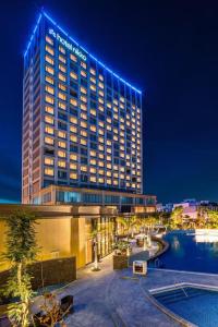 a hotel with a lit up building at night at 2BR Minato Apartment, Free Swimming Pool & Gym in Hai Phong