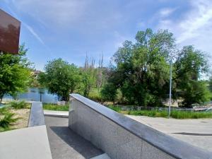 a retaining wall in a park with a body of water at Park Avenue Hotel in Taraz
