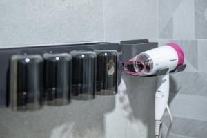 a blow dryer is hanging on a wall at Muxuan Homestay in Yuli