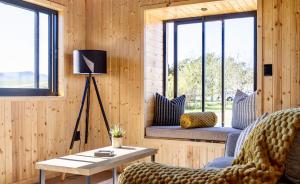 a living room with a couch and a table at Bietjiedam's The Barn in Caledon