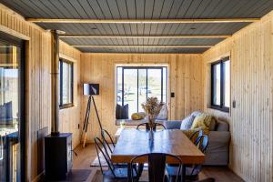 a living room with a table and a couch at Bietjiedam's The Barn in Caledon