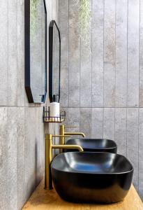 a bathroom with a black tub and a sink at Bietjiedam's The Barn in Caledon +24 photos