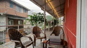 two chairs and a table with a laptop on a balcony at SPKA Jungle Resort in Vālpārai